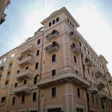 Proseguiamo su via XXIV Maggio sino alla traversa di via Giuseppe Bozzi, dove si innalza un alto palazzo rosa contraddistinto da due �torrini� al piano attico